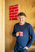 Richard在他的作品Red Brick旁，红砖的Logo跟他手上的杯子相映成趣。
